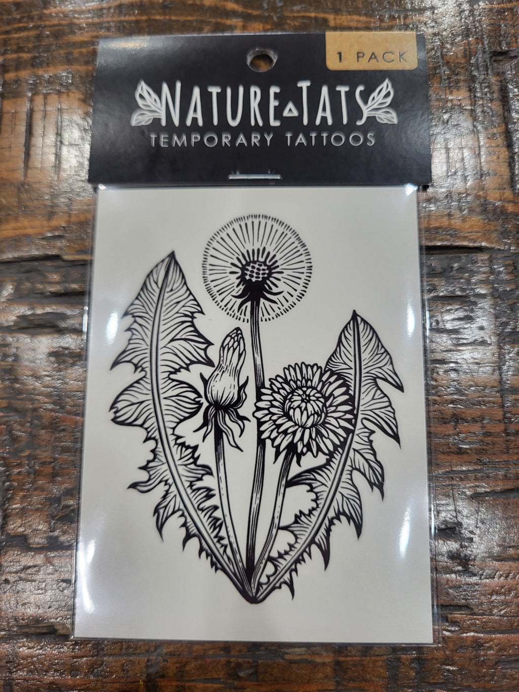 Temporary tattoo sheet pack showing dandelion, rabbit, and leafy floral design in black