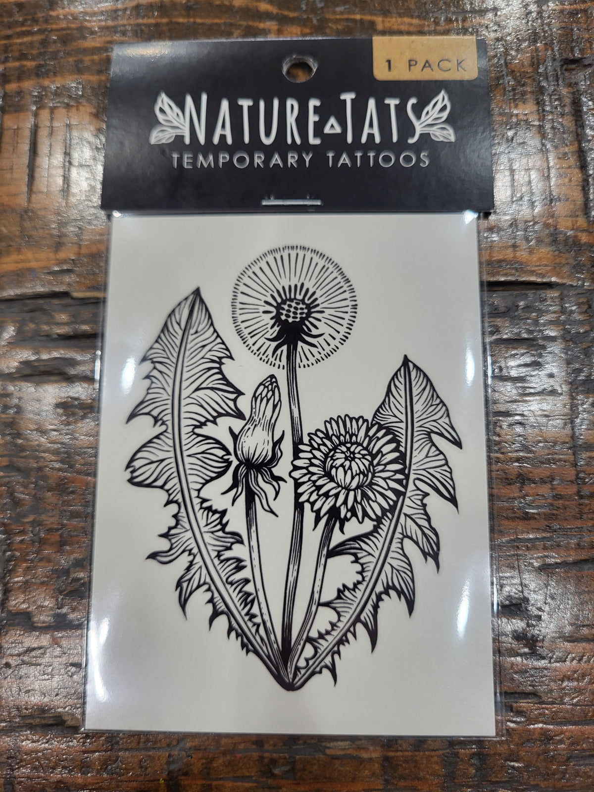 Temporary tattoo sheet pack showing dandelion, rabbit, and leafy floral design in black