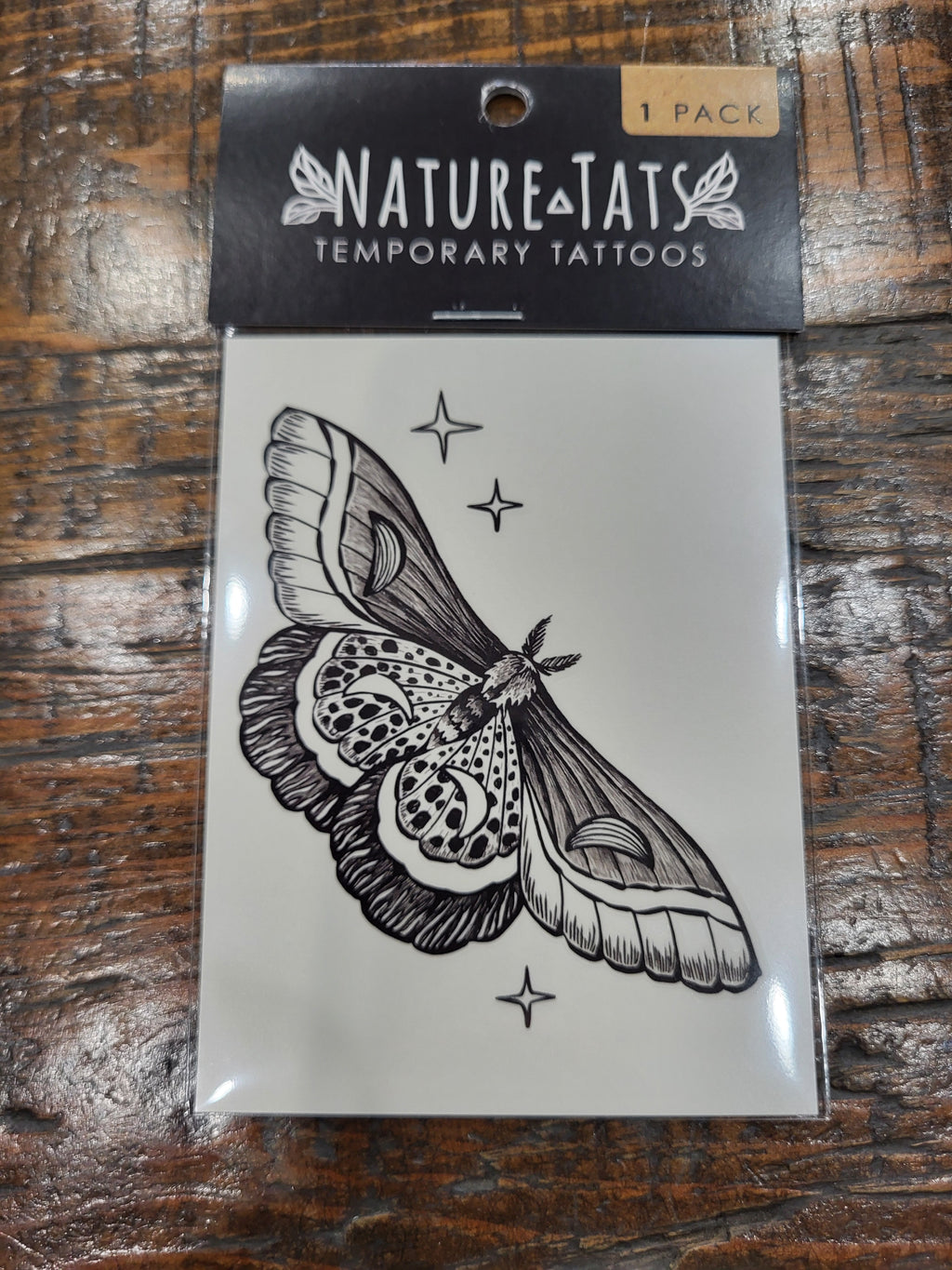 Night moth temporary tattoo sheet, black moth illustration with small star sparkles.
