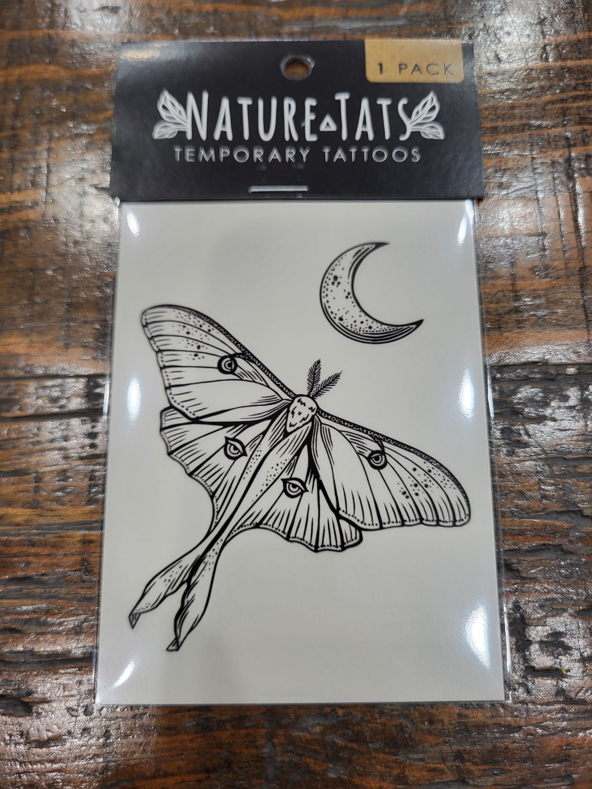 Temporary tattoo pack with black line art moth and crescent moon
