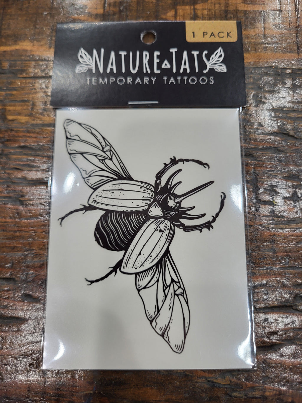 Rhinoceros beetle temporary tattoo pack, black line-art beetle on clear sleeve