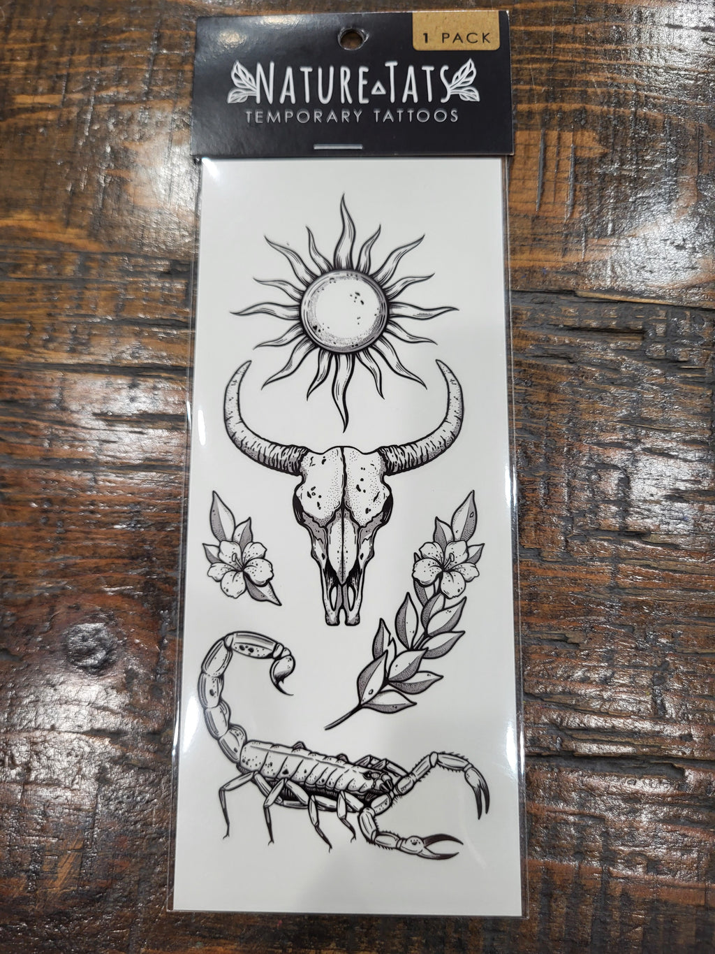 NatureTats temporary tattoo sheet with sun, bull skull, scorpion, and flowers
