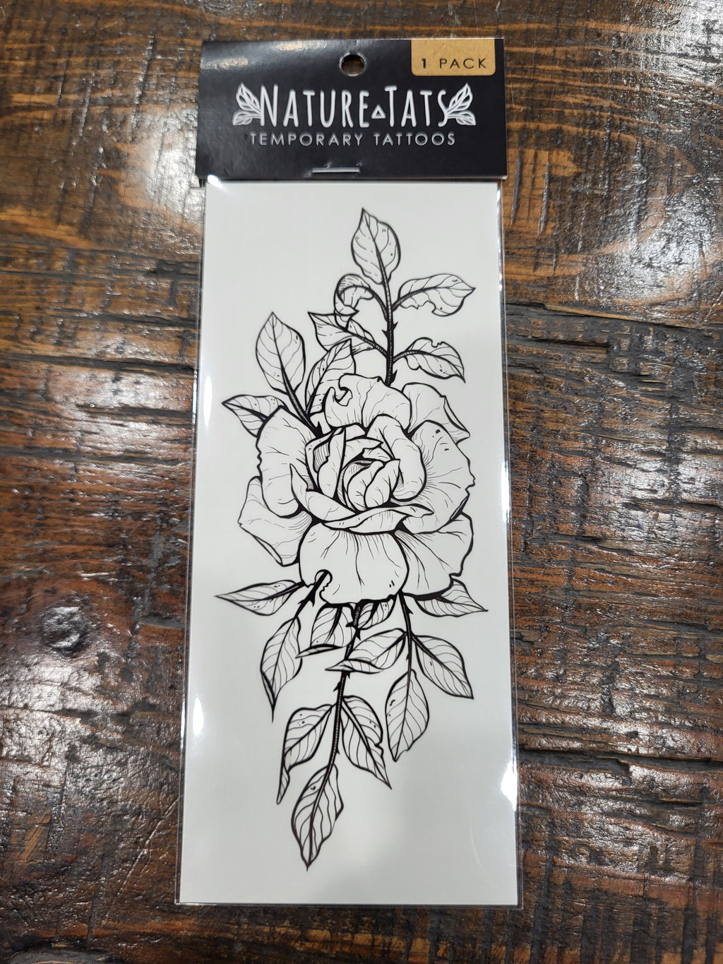 Temporary tattoo sheet with black rose blossom and leaves line illustration