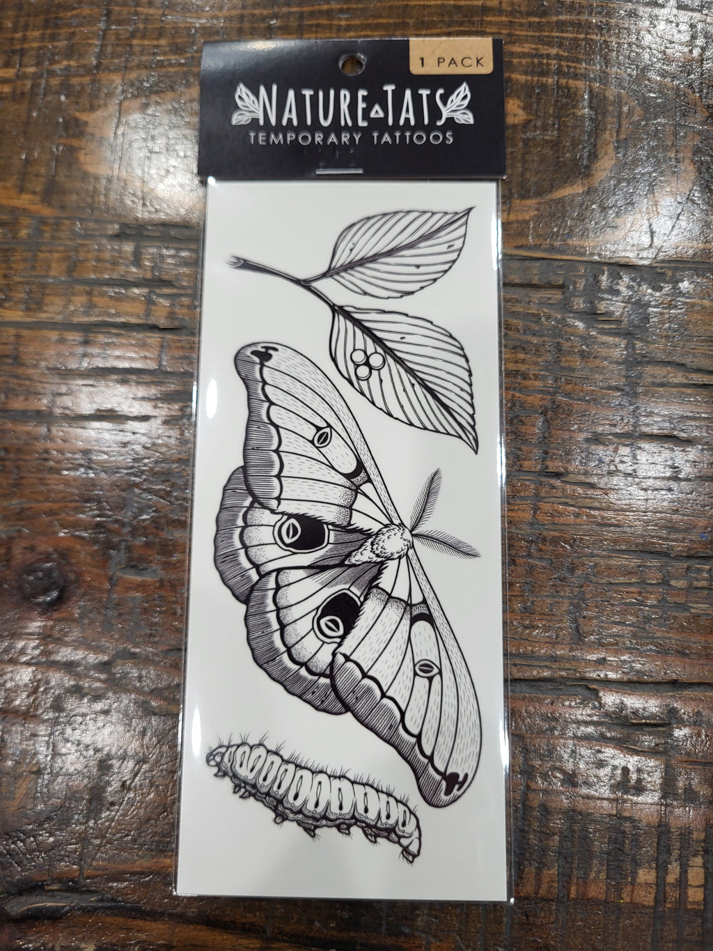 Temporary tattoo sheet featuring a moth and leaf wing design in black