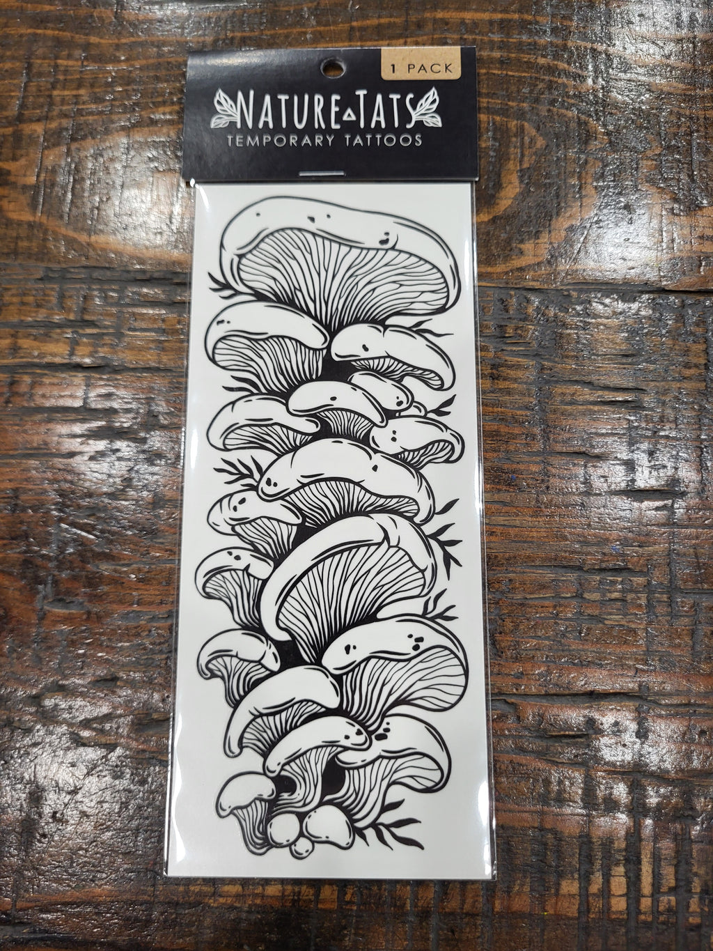Temporary tattoo sheet with black line art oyster mushrooms in a hanging package