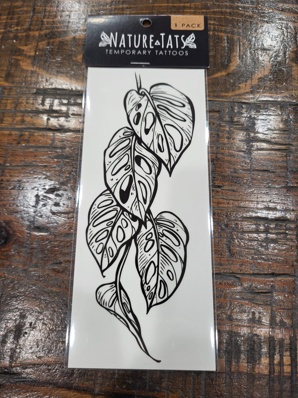 Monstera vine temporary tattoo sheet with black outline leaf design