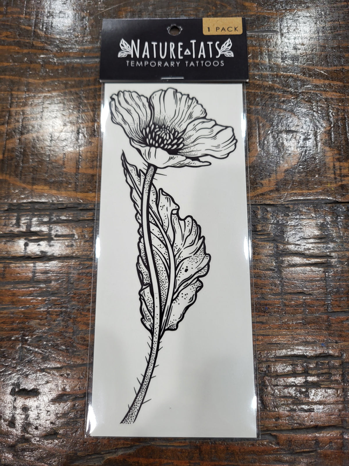 Wild poppy temporary tattoo sheet in black, NatureTats package with flower illustration