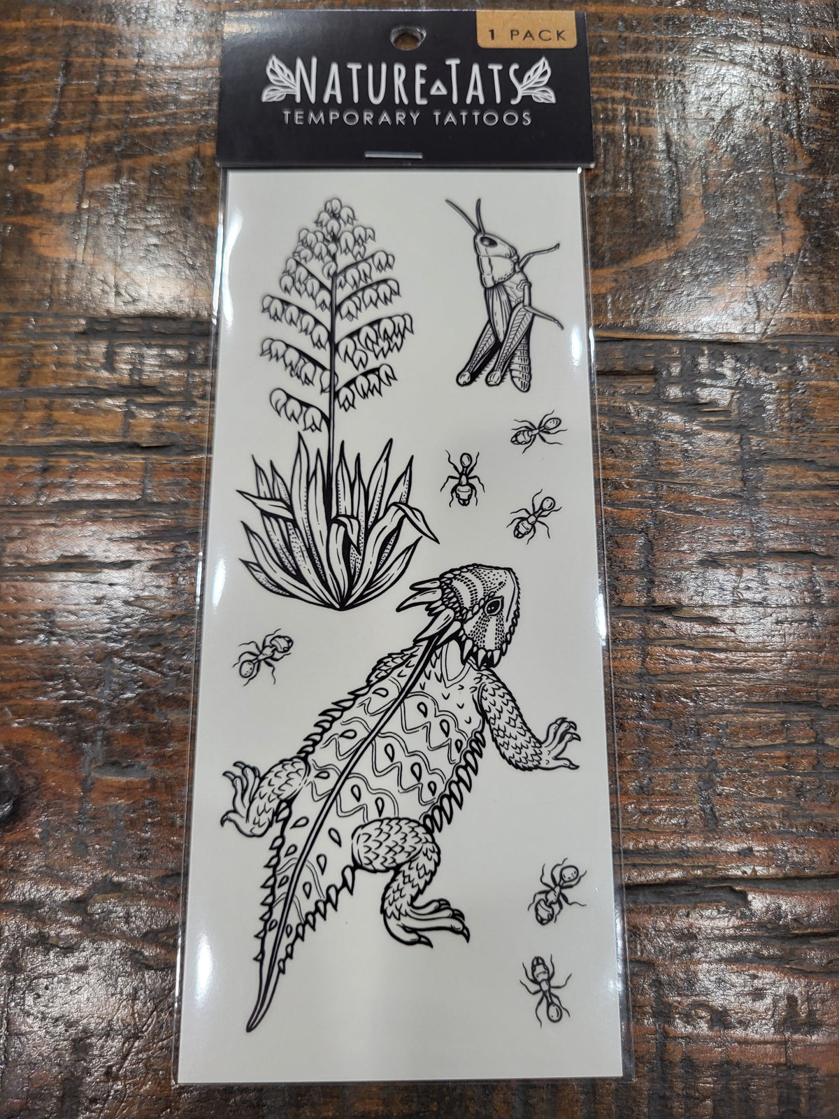 Temporary tattoo pack showing line drawings of horned lizard, yucca, and insects