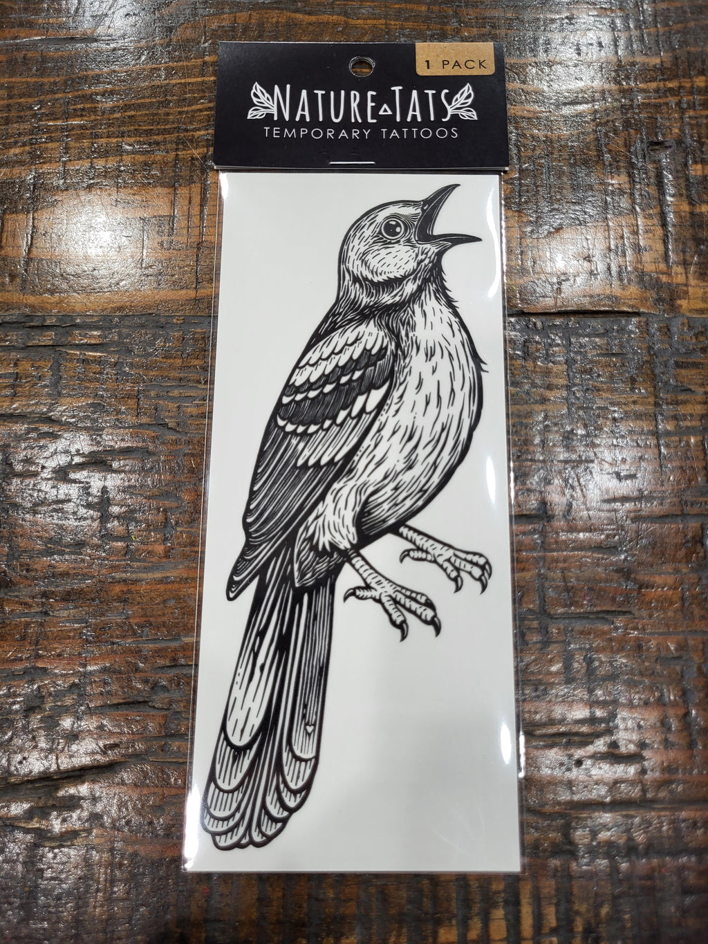 Temporary tattoo pack with black-and-white mockingbird design