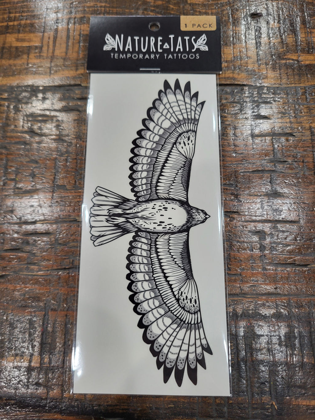 Temporary tattoo sheet with black hawk bird wing design in package