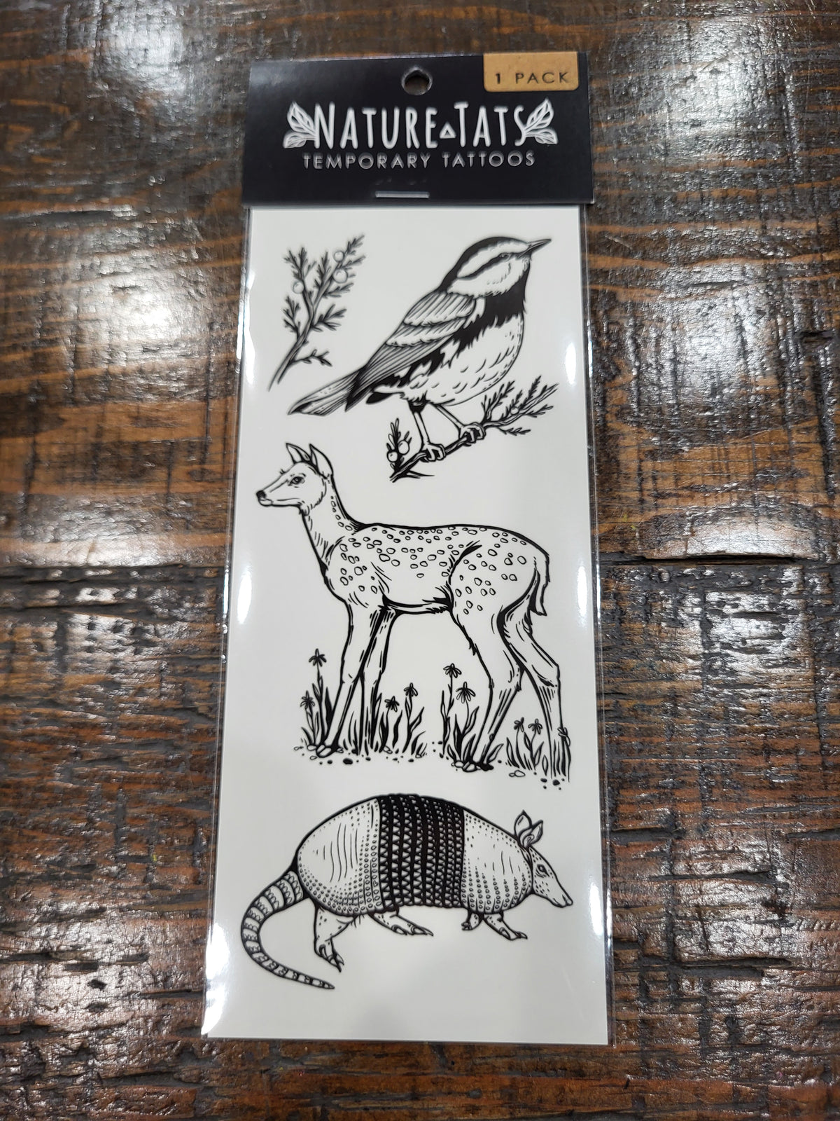 NatureInspired temporary tattoo set with bird, deer, armadillo, and plant icons on card