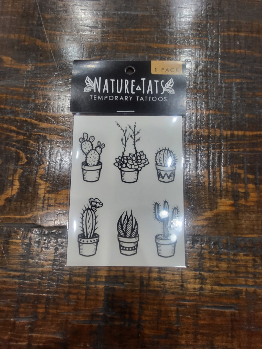 Temporary tattoo sheet pack with six potted cactus outline designs