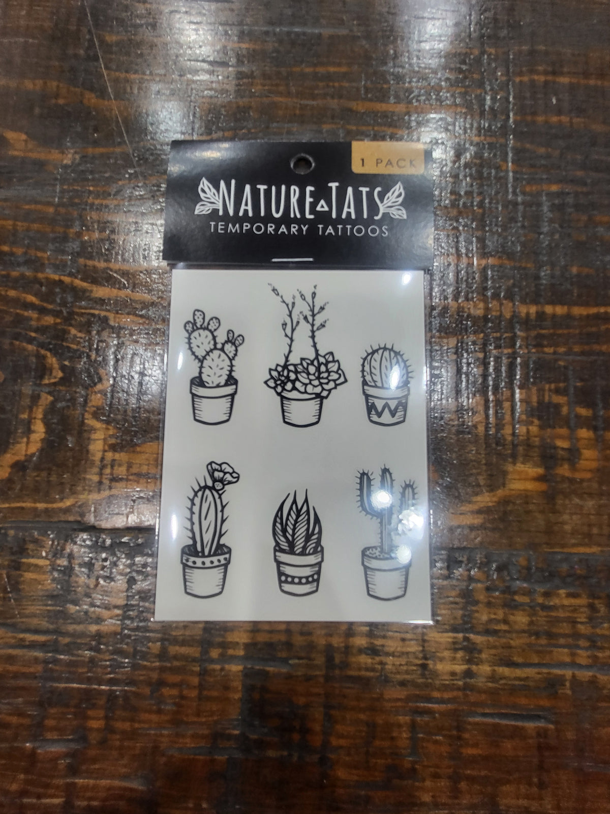 Temporary tattoo sheet pack with six potted cactus outline designs