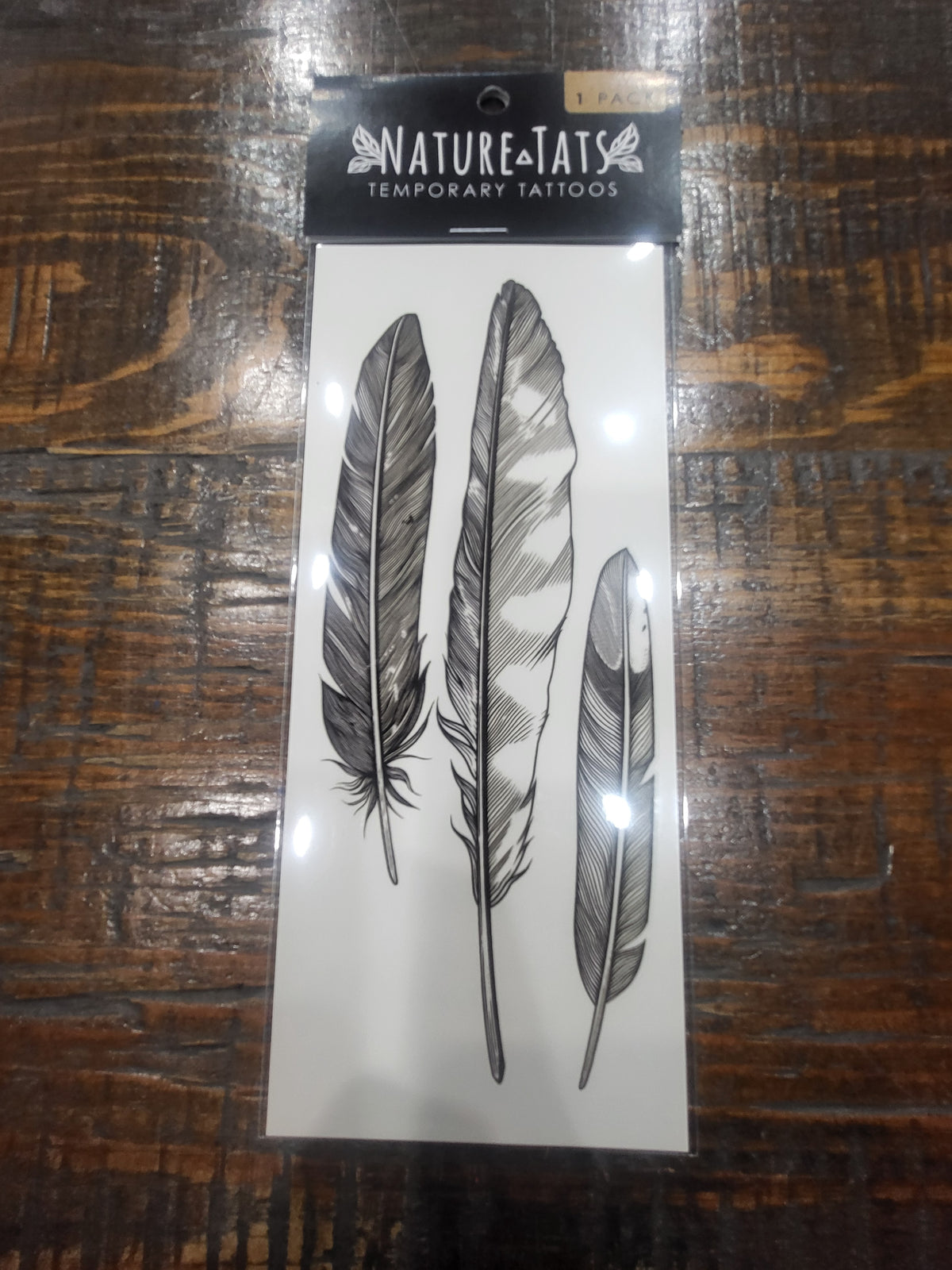 NatureTats temporary tattoo pack with three gray feather tattoo designs