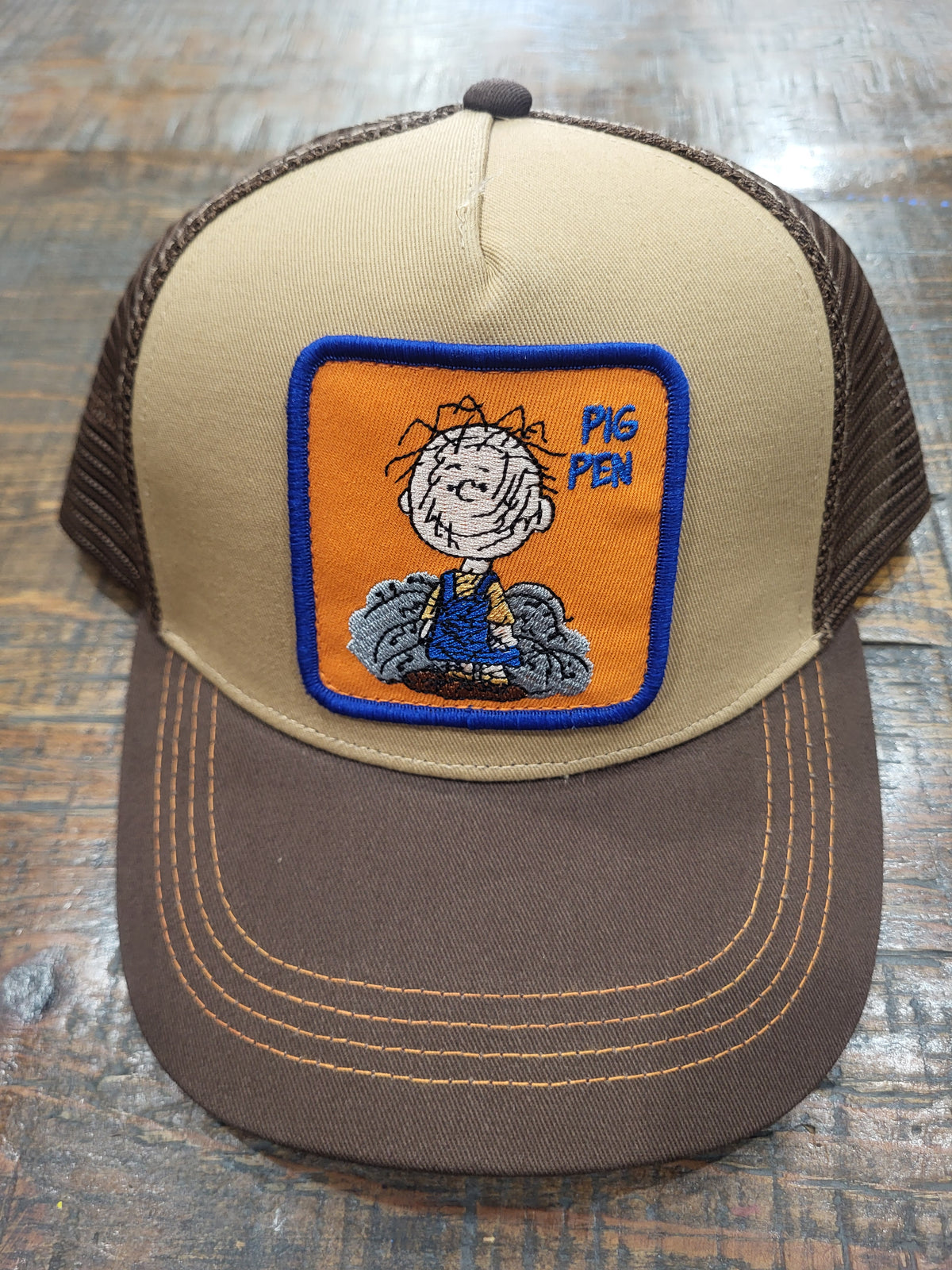 Cotton mesh trucker hat in light beige and dark brown with embroidered Pig Pen patch