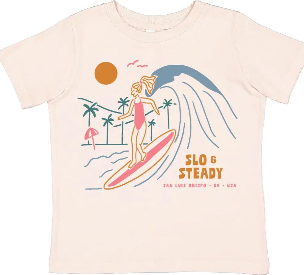 Light pink toddler graphic t-shirt with surfer girl on surfboard and SLO text