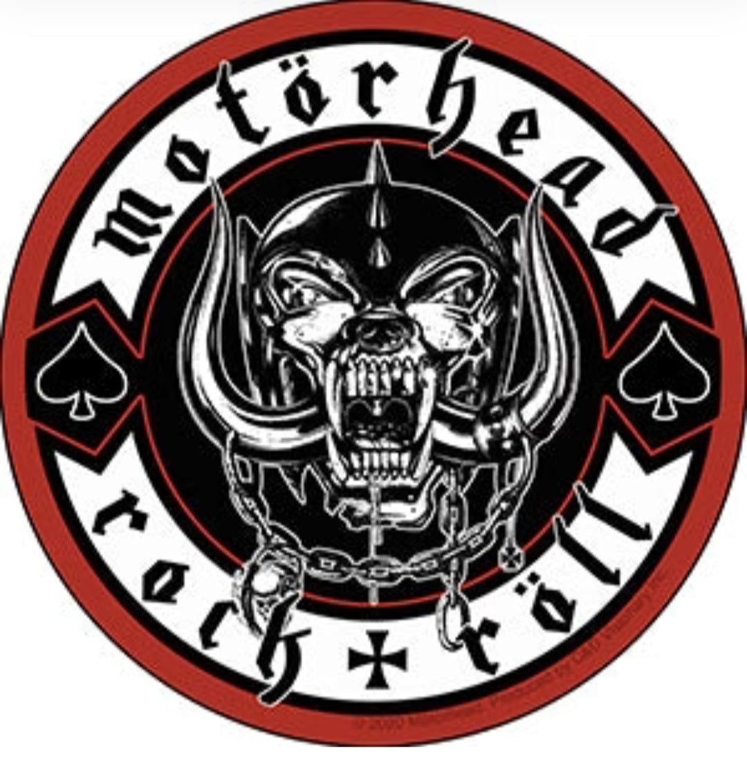 Round band sticker with black skull face, red border, and playing card icons