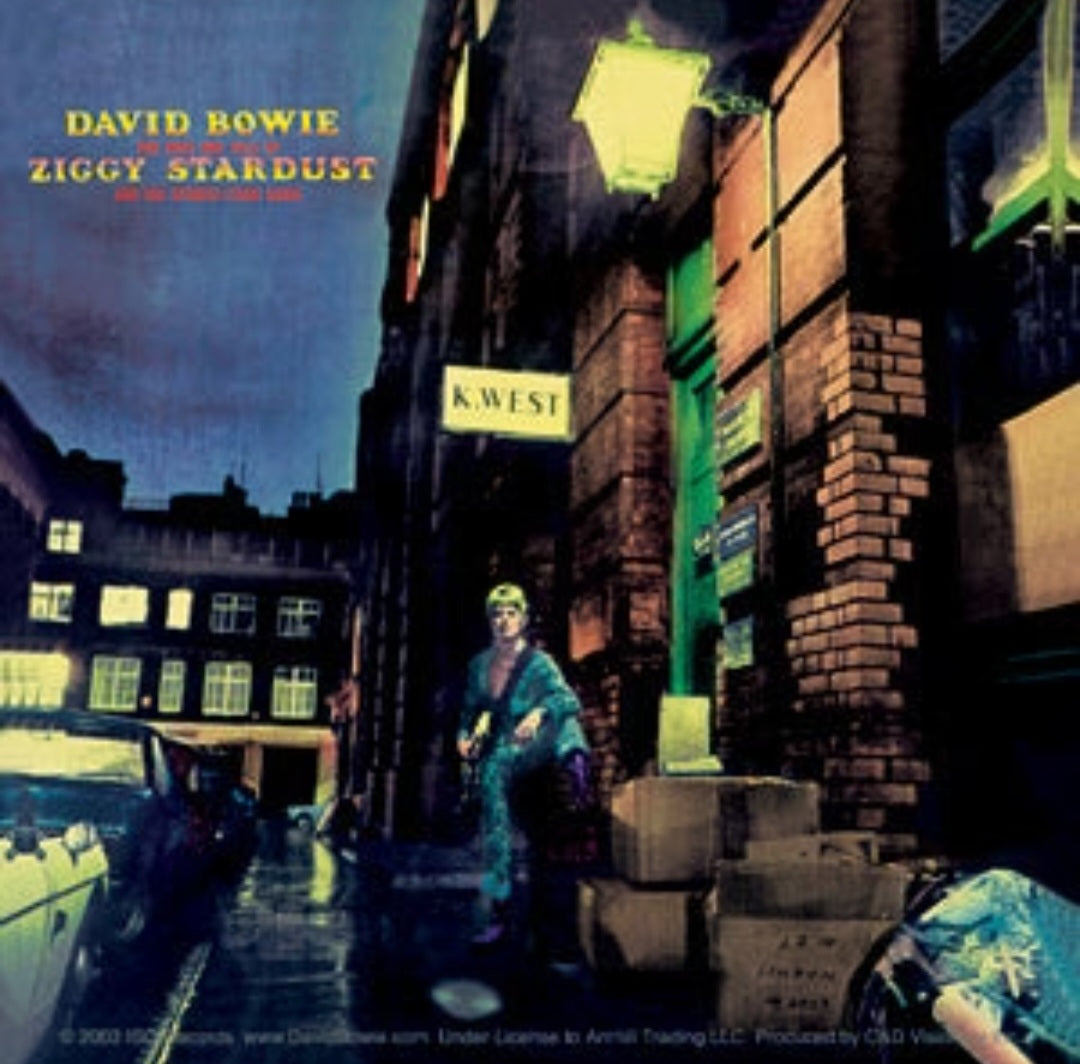 Music band sticker featuring Ziggy Stardust-style portrait and city street art