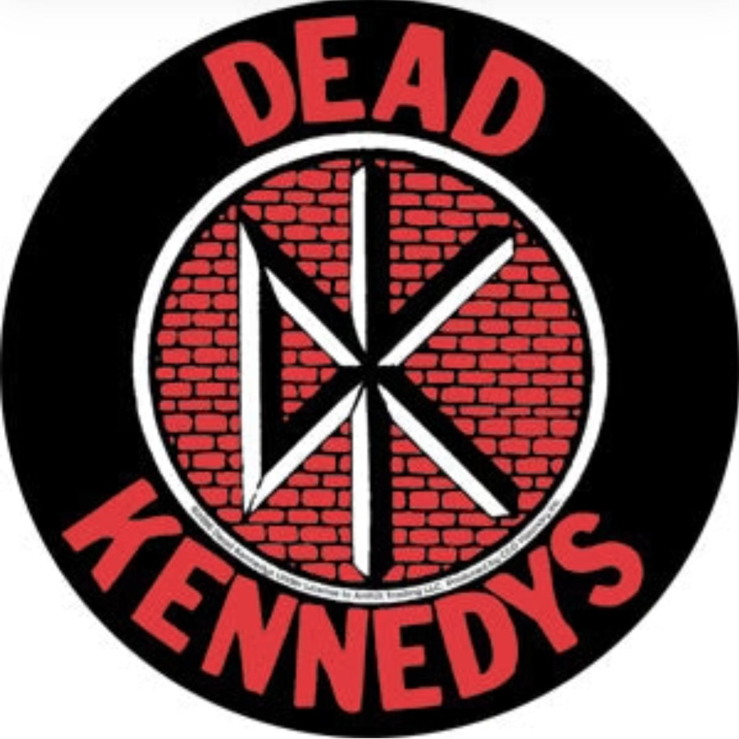 Round black band sticker with red brick center and red "DEAD KENNEDYS" text
