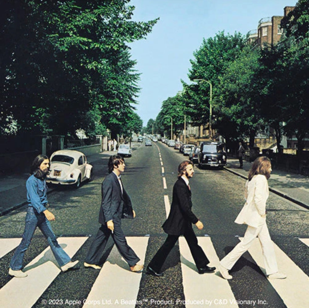 The Beatles band sticker showing four musicians walking across a city street