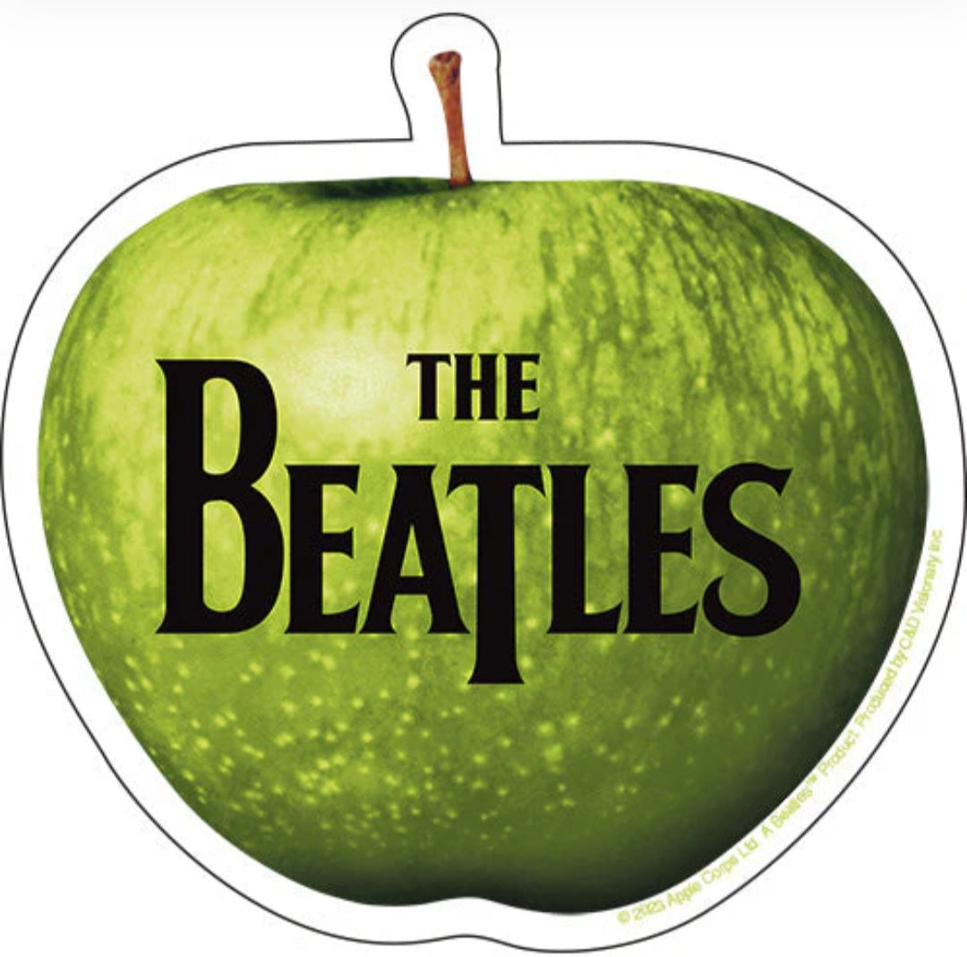 Green apple-shaped Beatles band sticker with 'THE BEATLES' text