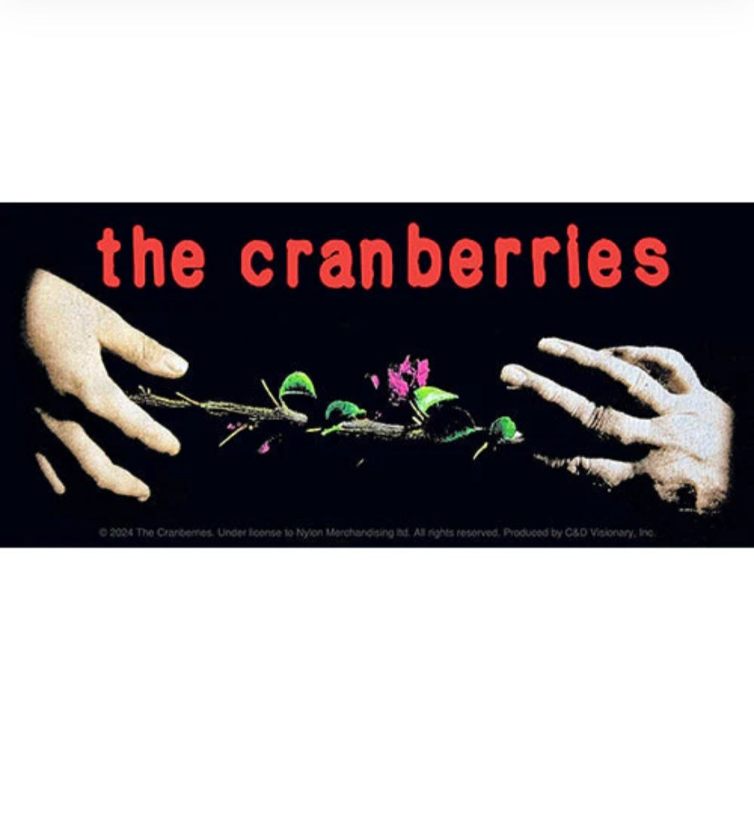 Band sticker with red title text, two hands, and floral graphic on dark background
