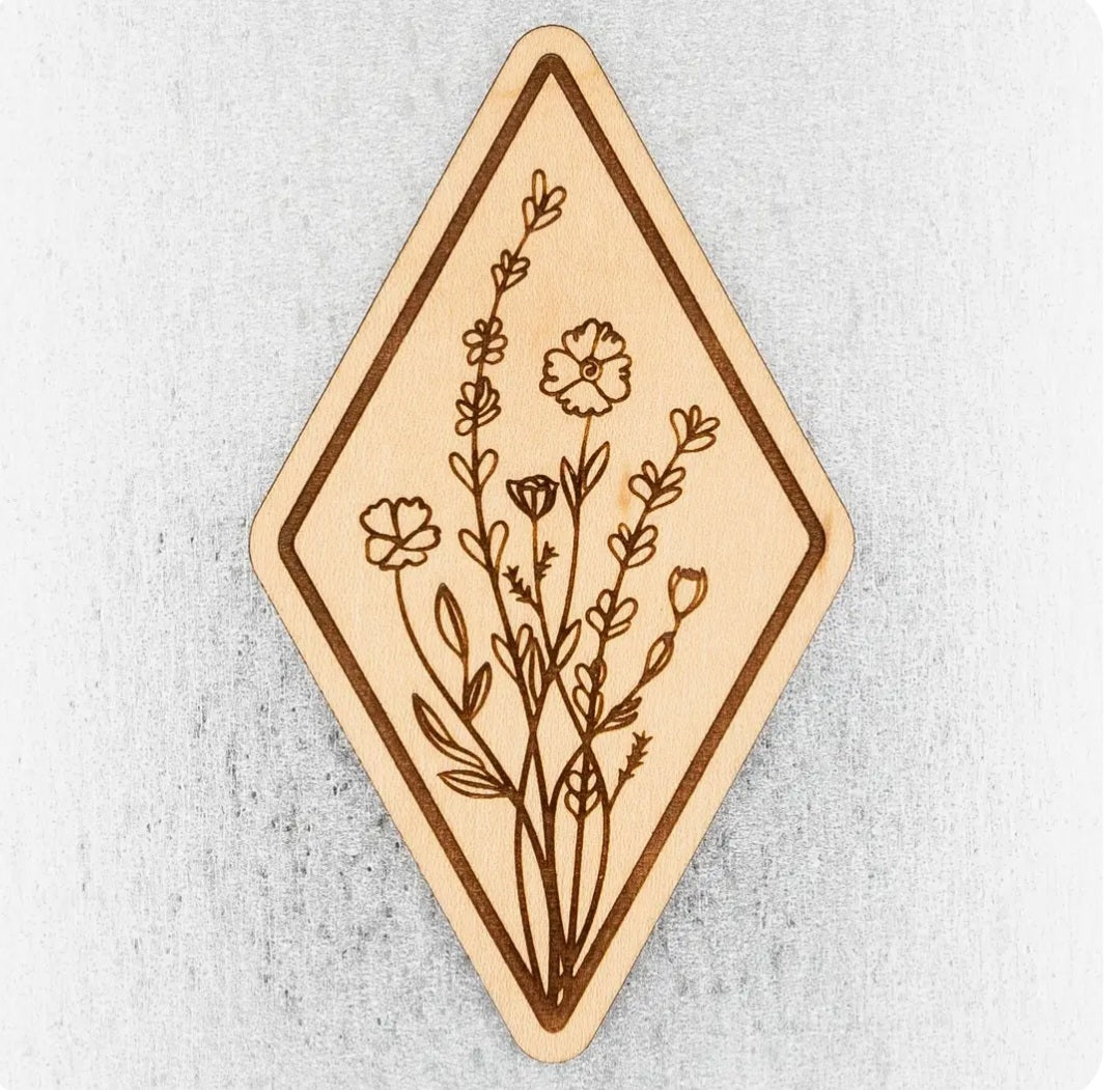 Wooden diamond magnet with engraved wildflower stems and small blossoms