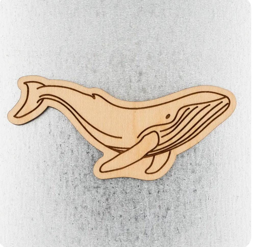 Humpback whale wood magnet, carved tan whale design on a blank surface