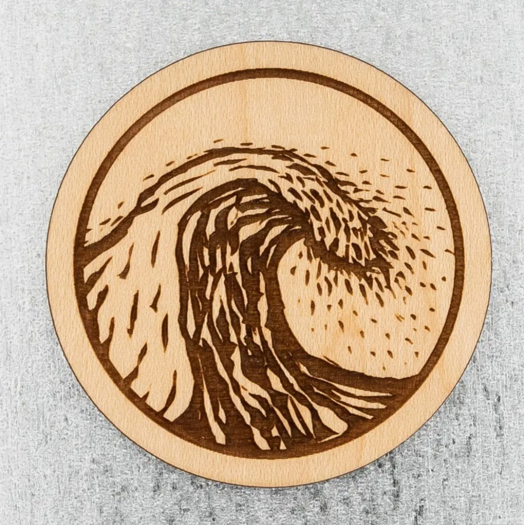 Round wood magnet with carved ocean wave swirl graphic