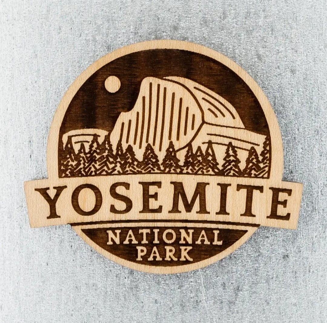 Wooden circular magnet with Yosemite National Park text and mountain forest graphic