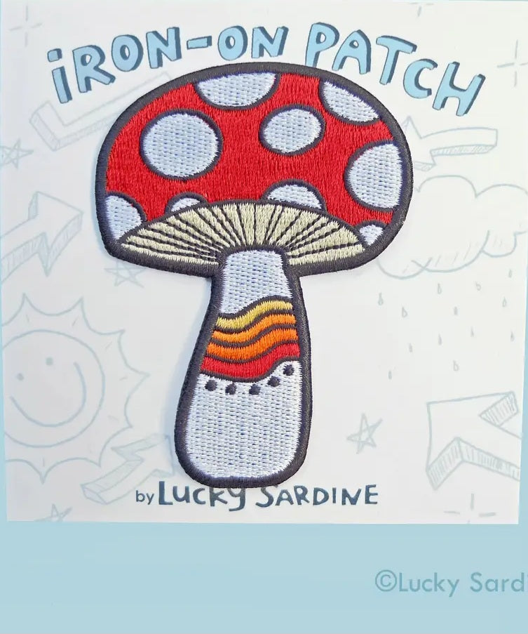 Iron-on mushroom patch with red cap, white spots, and rainbow-striped stem