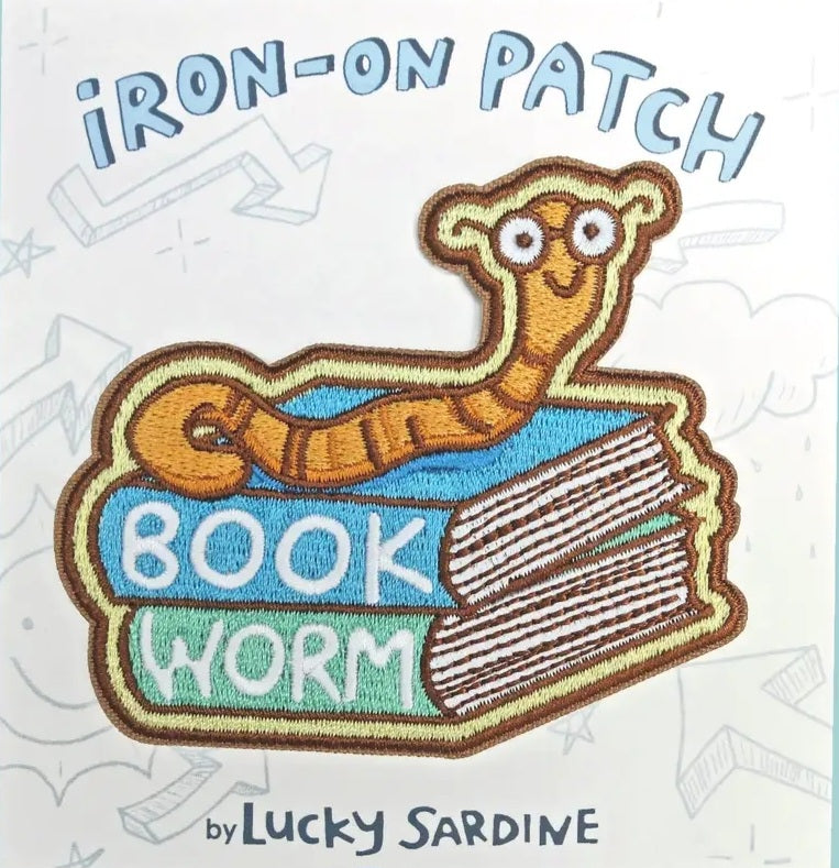Iron-on patch of a book worm with glasses on stacked books