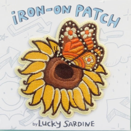 Iron-on patch featuring a butterfly over a sunflower, embroidered multicolor design