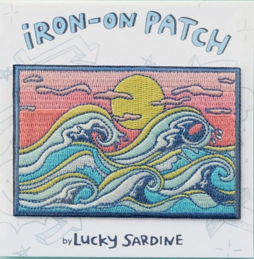 Rectangular iron-on patch with colorful crashing waves and yellow sun on pink background