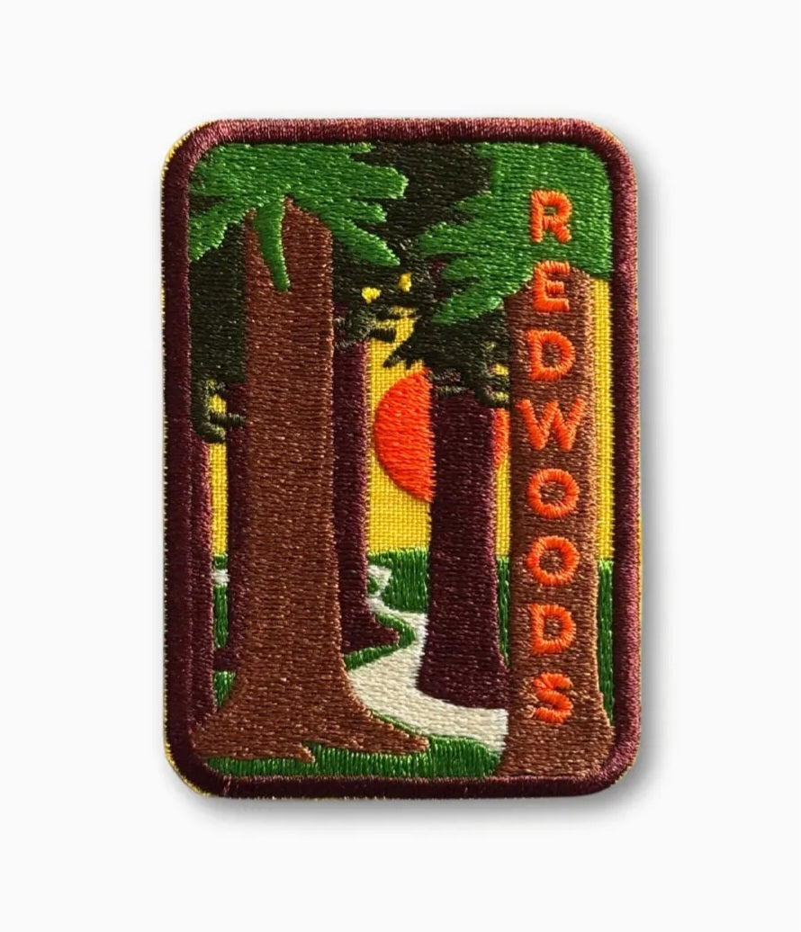 Rectangular iron-on patch with green redwood trees and red REDWOODS lettering