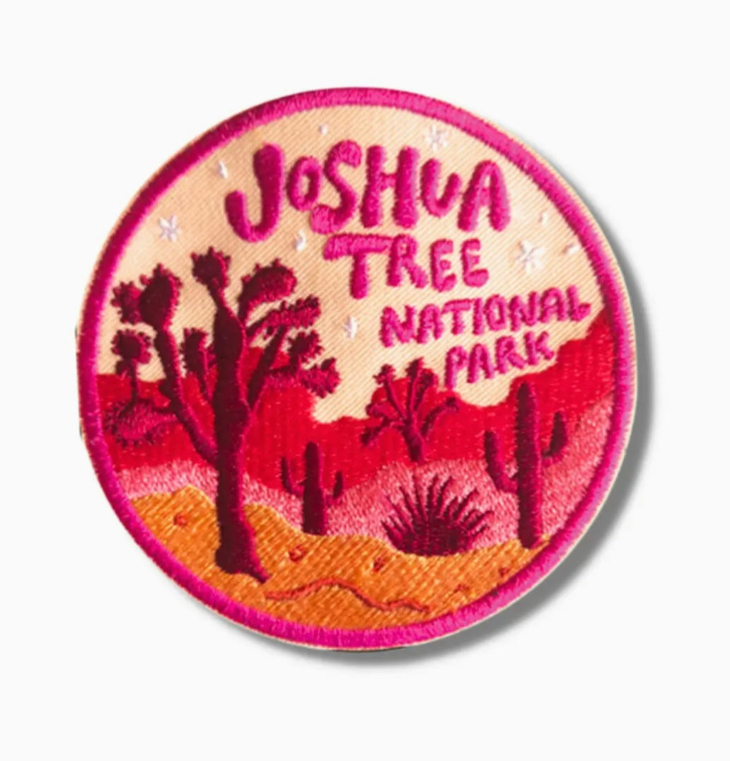 Round iron-on patch with Joshua Tree National Park text and desert cactus scene, pink border.