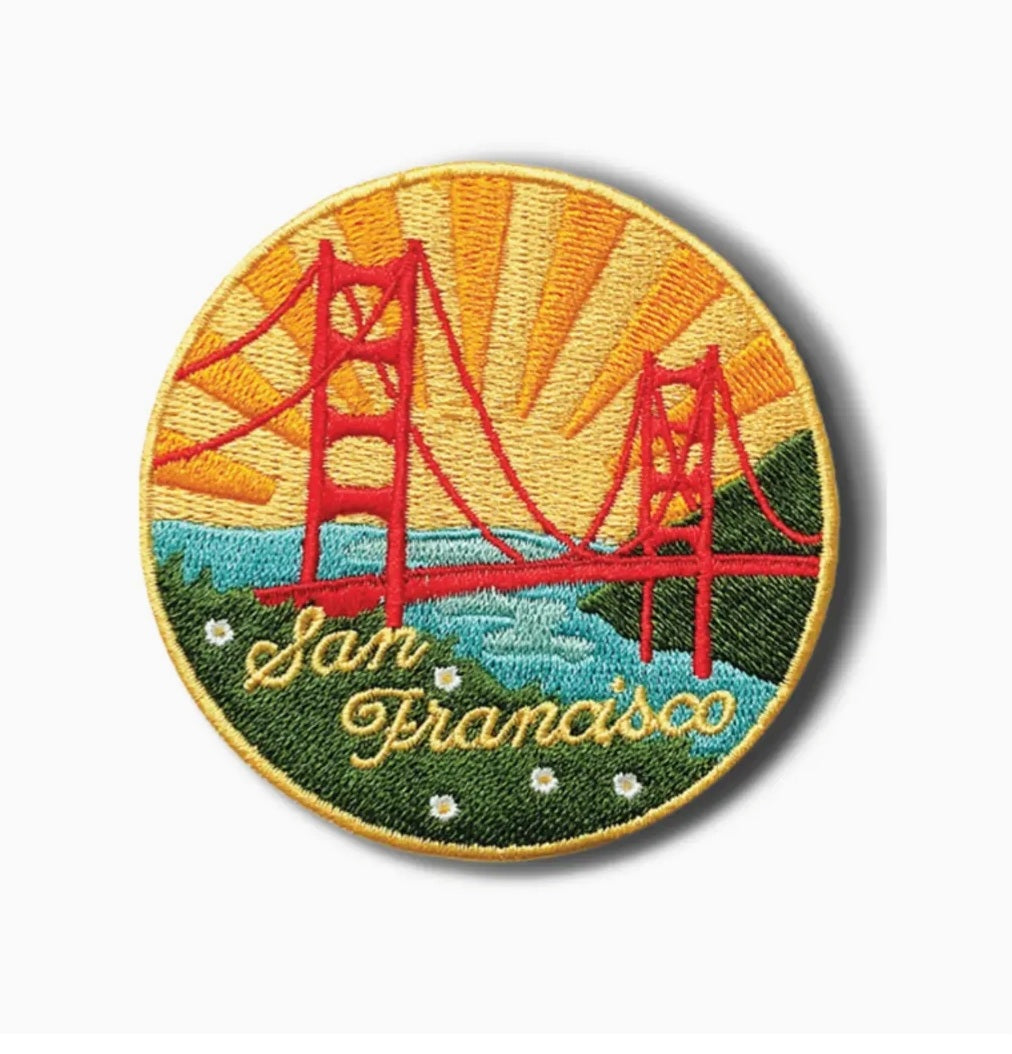 Round embroidered iron-on patch with red bridge towers, blue water, and 'San Francisco' text
