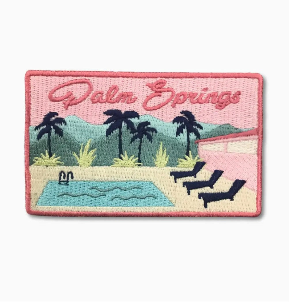Rectangular iron-on patch with pink border, 'Palm Springs' text, palm trees and pool