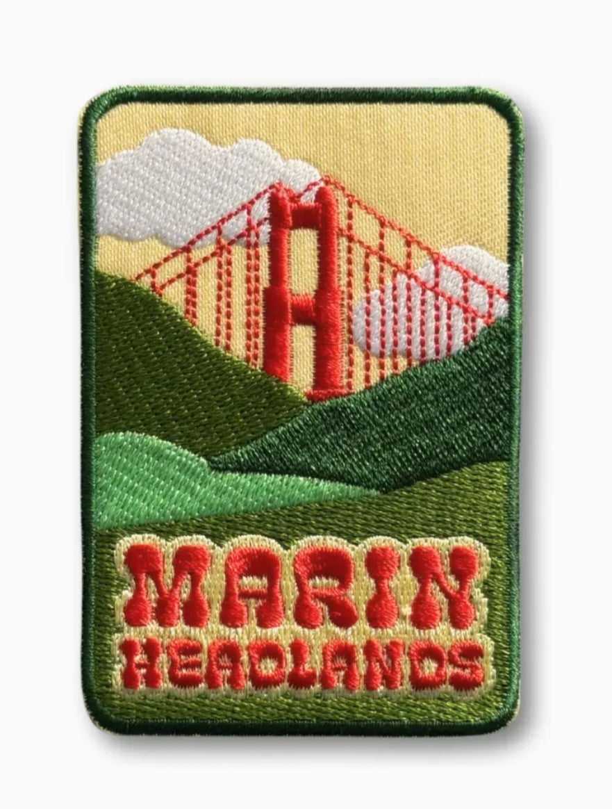 Green iron-on patch with yellow sky, red bridge, and red “Marin Headlands” text
