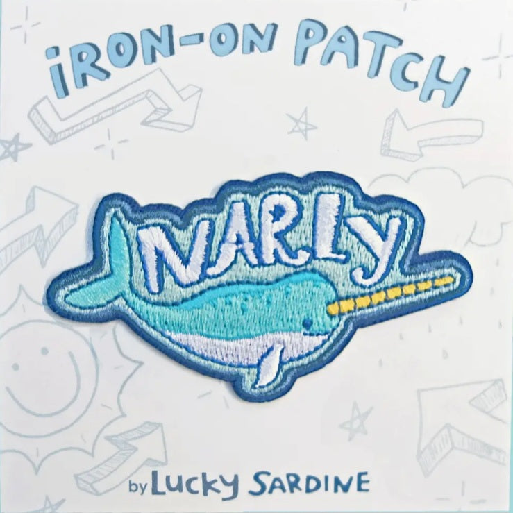 Iron-on narwhal patch with blue stitched lettering and Lucky Sardine branding