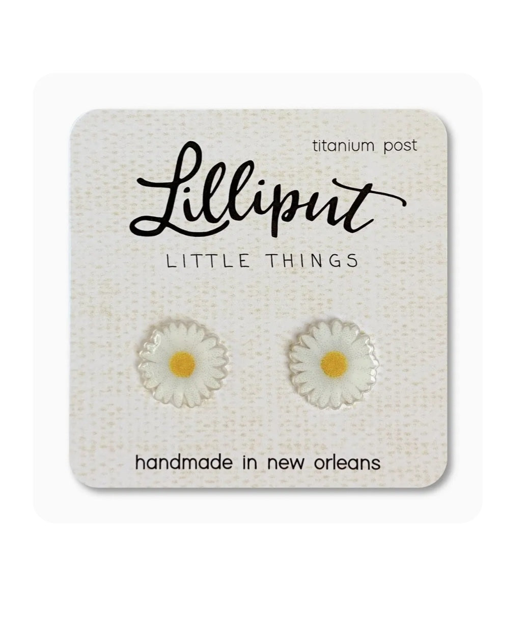 Small daisy stud earrings with white petals and yellow centers, titanium posts