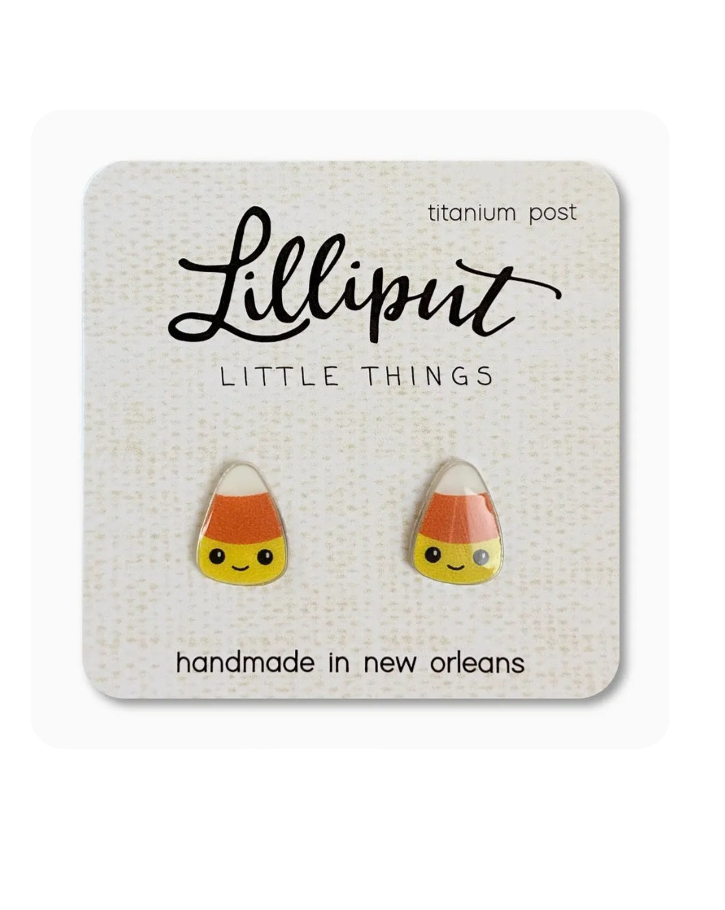 Candy corn stud earrings with titanium posts, yellow, orange, and white enamel.