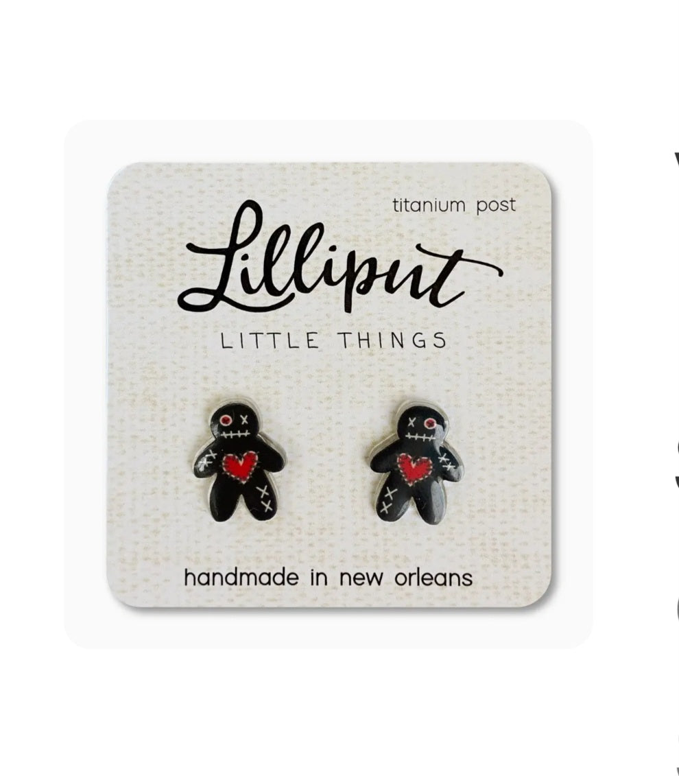 Pair of small black doll-shaped earrings with red heart accents, titanium posts