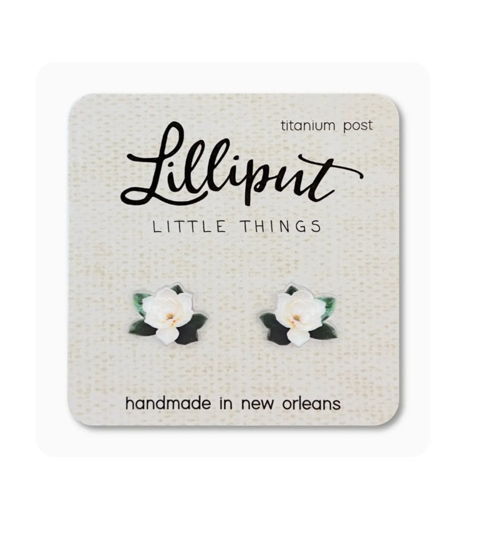 Magnolia flower earrings with white petals, green leaves, and titanium posts