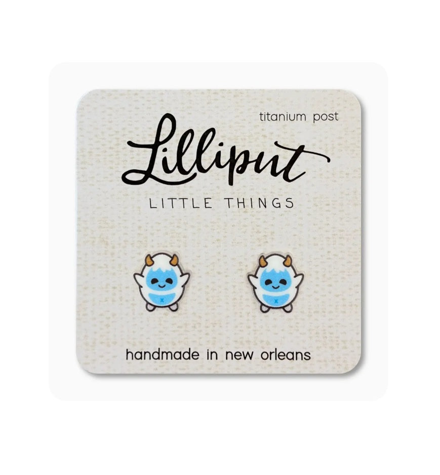 Blue cartoon stud earrings with gold accents, on card with titanium posts