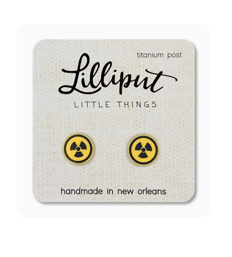 Small gold-tone stud earrings with black radiation symbol, titanium posts