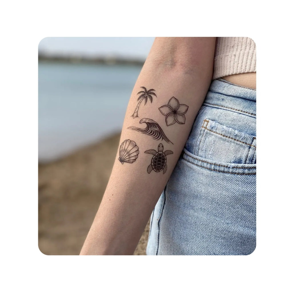 Temporary tattoo on arm with palm tree, turtle, flowers, and seashell line art