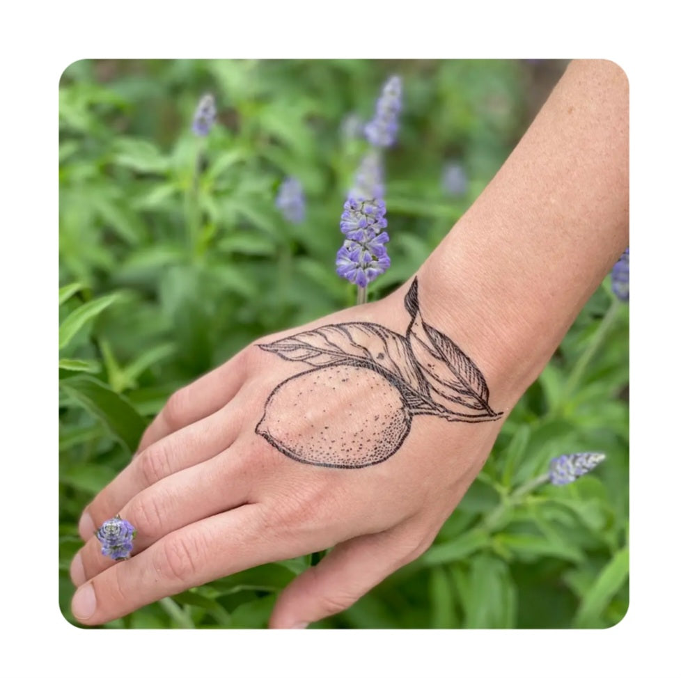 Temporary lemon leaf tattoo on wrist with dotted fruit and branch design