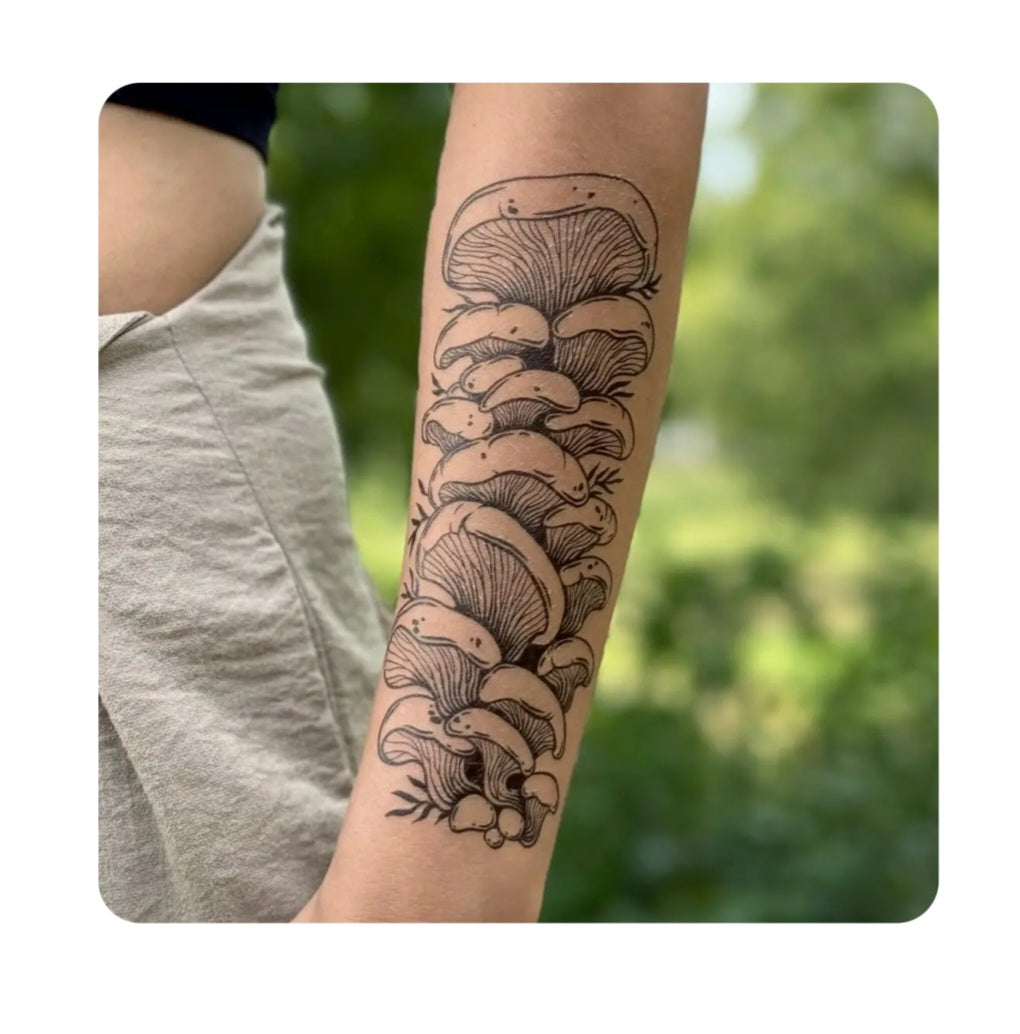 Temporary oyster mushroom tattoo on forearm in black ink, detailed line illustration