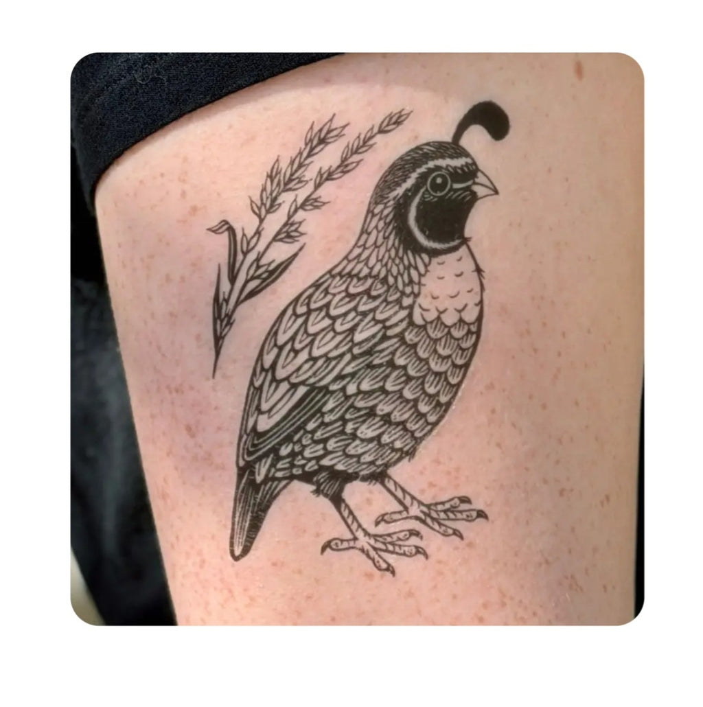 Quail temporary tattoo of a black-and-gray bird with leafy branch on skin